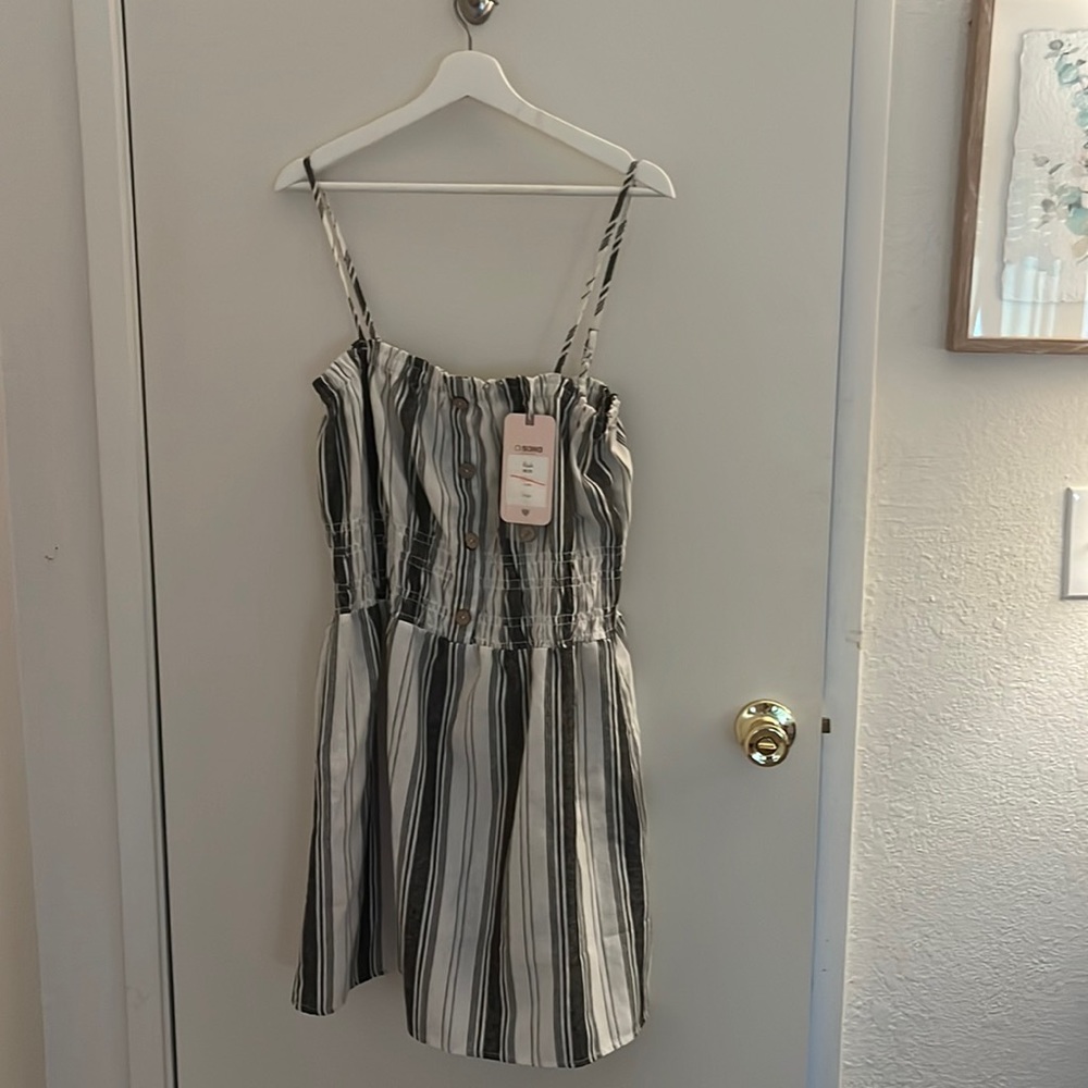 White and black striped sundress, adjustable strap and button top. Stretchy top